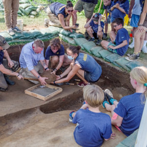 Senior Conservator Dan Gamble helps the archaeologists remove the UFO (Unidentified Ferrous Object) from Fort Pocahontas' moat.