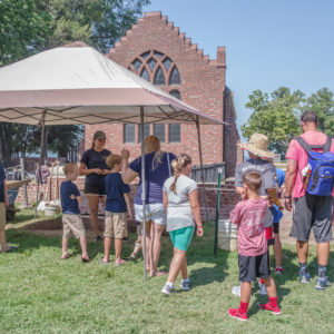 Nicole Roenicke talks to visitors at the churchyard site