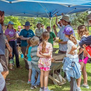 Field school student Aidan Sherwin shares some of the week's finds with students, staff, and visitors.