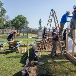 The archaeological team covers the burial structure in plastic.