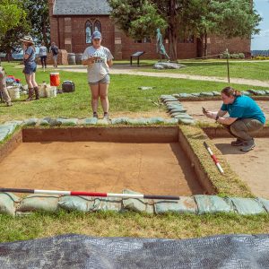Field school students Jordan Searcey and Molly Morgan take digital photographs as part of the process to create a digital 3D model of one of the squares at the cellar excavations.