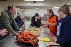 (L-R) William & Mary professor Dr. Jim Kaste, Senior Staff Archaeologist Mary Anna Hartley, Senior Staff Archaeologist Sean Romo, William & Mary professor Dr. Chuck Bailey and Associate Curator Janene Johnston discuss some of the stones found in the Governor's Well.