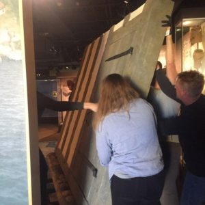 Workers install new museum panels