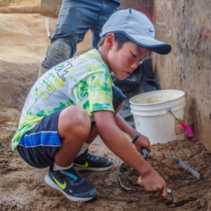 A camper digging in the Confederate moat.