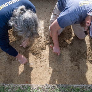Staff Archaeologist Gabriel Brown and Archaeological Field Technician Josh Barber carefully trowel away inside one of the Smithfield squares.