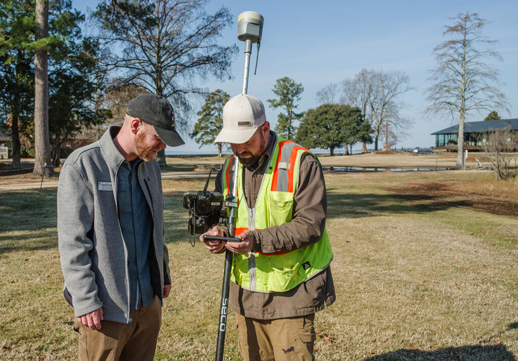 Director of Archaeology Sean Romo consults with the VHB surveyor as part of the Memorial Church drainage project.