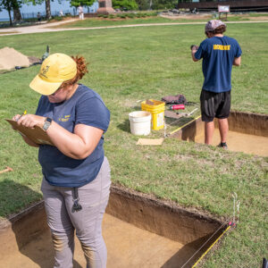 Archaeological Field Technicians Hannah Barch and Josh Barber record measurements of the excavations squares in Smithfield.