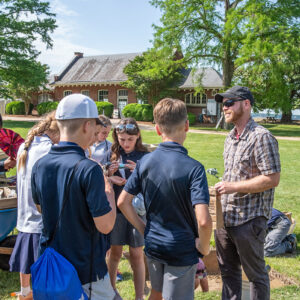Director of Archaeology Sean Romo shares some recently found artifacts with visitors.