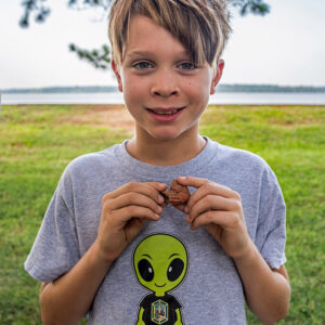 A camper holds a clay pipe bowl he found during his excavations.