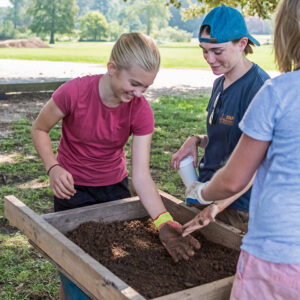 Staff Archaeologist Natalie Reid supervises screening during Kids Camp.