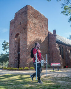 Dr. David Leslie of TerraSearch Geophysical performs a magnetometry survey of the grounds surrounding the Church Tower and Memorial Church.