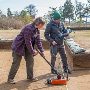 Archaeological Field Technician Eleanor Robb and Staff Archaeologist Gabriel Brown conduct a GPR survey of the excavations close to the Godspeed Cottage.