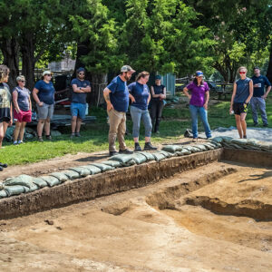 Senior Staff Archaeologist Sean Romo describes the pug mill excavations to members of Colonial Williamsburg's brickyard team.