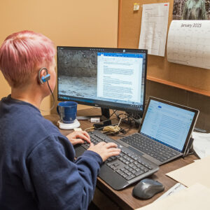 Staff Archaeologist Caitlin Delmas works on a report for recent excavations.