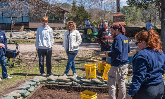 Archaeological Field Technicians Josh Barber and Hannah Barch share their findings with visitors to the excavations southwest of the Archaearium.