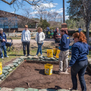 Archaeological Field Technicians Josh Barber and Hannah Barch share their findings with visitors to the excavations southwest of the Archaearium.