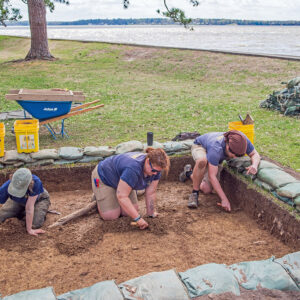 Archaeological Field Technicians Ren Willis, Hannah Barch, and Josh Barber excavate one of the new squares just southwest of the Archaearium.