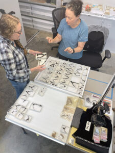 Associate Curator Janene Johnston and Sara Rivers-Cofield, Curator of Federal Collections of the Maryland Archaeological Conservation Lab examine Jamestown's spur collection during Ms. Rivers-Cofield's visit in 2021.