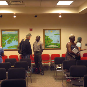 People standing and talking between chairs