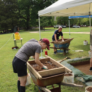 Screening soil from the excavations north of the fort