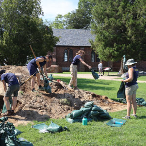 Jamestown Rediscovery archaeologists filling sandbags used to protect the excavation sites from rainwater drainage. The dirt used for sandbags is screened for artifacts prior to usage.