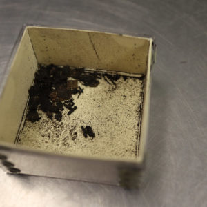 A box containing soil and textiles from the fort's first well.