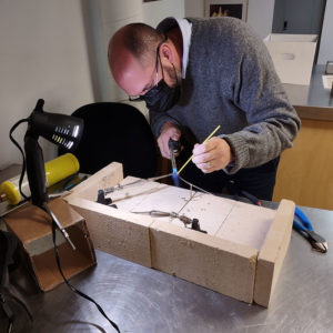 Director of Collections & Conservation Michael Lavin creates a mount for one of the artifacts in the "Gentleman Soldiers" exhibit