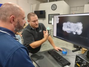 Director of Collections & Conservation Michael Lavin and Pinnacle's Matt Gormley review an X-ray of brigandine armor.