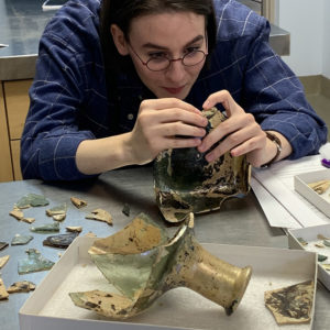 Intern Jackie Bucklew mending the case bottle