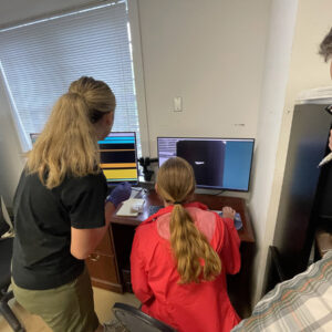 Field School students Katherine Griffith and Janne Wagner learn to use an X-ray machine with the guidance of Archaeological Conservator Dr. Chris Wilkins.