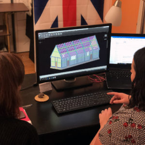 Two staff members examine digital model of church