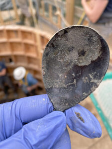 The copper alloy spoon found in the Governor's Well.  Note the maker's mark near the handle.