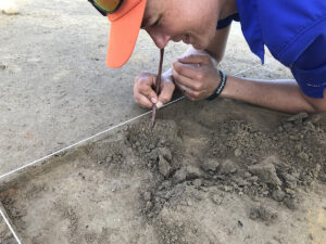 Senior Staff Archaeologist Mary Anna Richardson Hartley excavates one of the subfloor pits in the north field excavations.