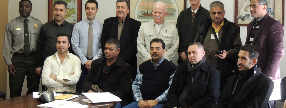 Staff and delegation pose for a group photo