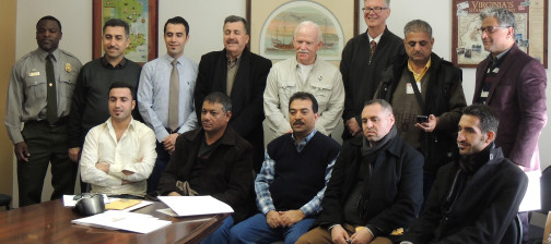 Staff and delegation pose for a group photo