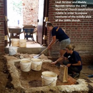 Two excavators shovel unit inside brick church doorway