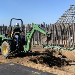 archaeologist operating a backhoe