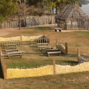 low mud-and-stud walls surrounding benches and grave markers