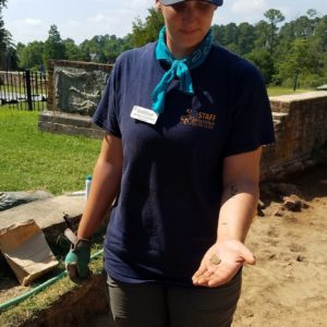 Archaeologist shows artifact to camera