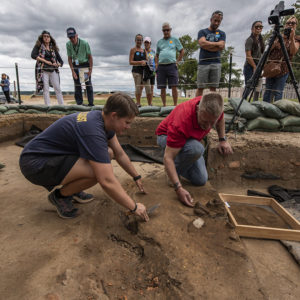 Staff Archaeologist Caitlin Delmas and Senior Conservator Dan Gamble excavate brigandine armor found at the north Church Tower excavations.