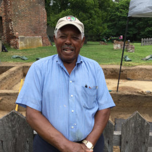 Man stands in front of excavations