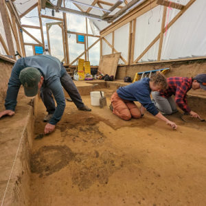 Senior Staff Archaeologist Sean Romo, Archaeological Field Technician Brenna Fennessey, and Senior Staff Archaeologist Mary Anna Hartley trowel away the layers above the three burials.