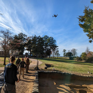 The drone taking photographs of the "burial" north field excavations.