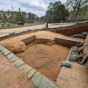 The 1610s well and builder's trench (dark circle around the well).