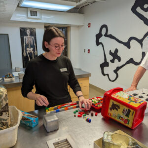 Intern Jackie Bucklew hard at work building a mount for the glass case bottle.