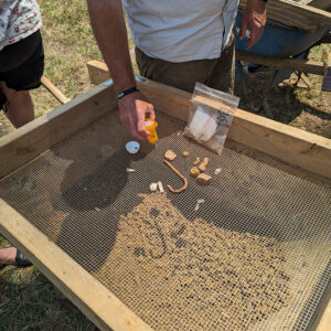 A screen of artifacts found at the west "flag" excavation units. Note the early 17th-century fishhook.