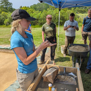 Field School student Katherine Griffith shares artifacts found at the north field excavations.