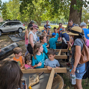 Campers share their artifact finds with family on the last day of camp.