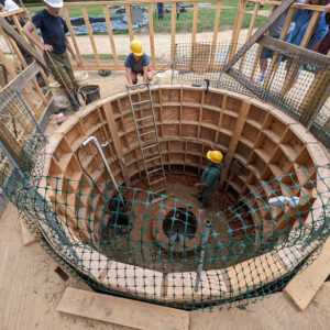 The archaeological staff built a French drain to help keep water away from the working surface.