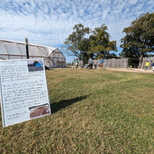 The burial structure. Archaeologists and volunteers explain the excavations to visitors.